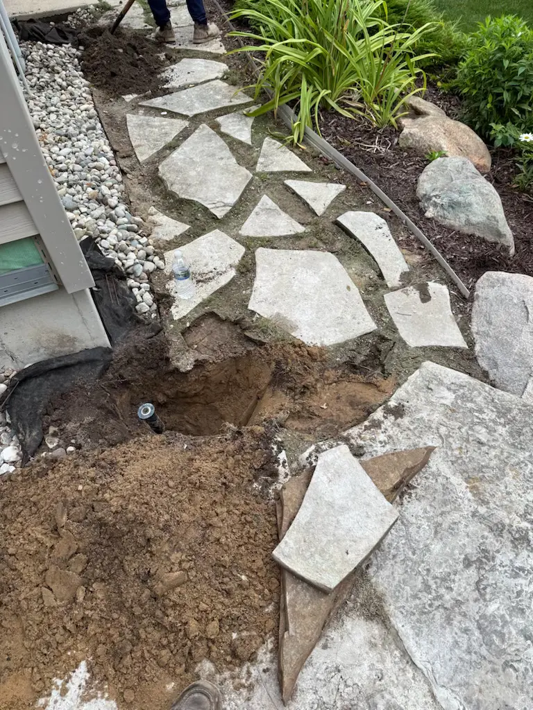 Michigan property with old concrete sidewalk before professional renovation by landscaping contractor