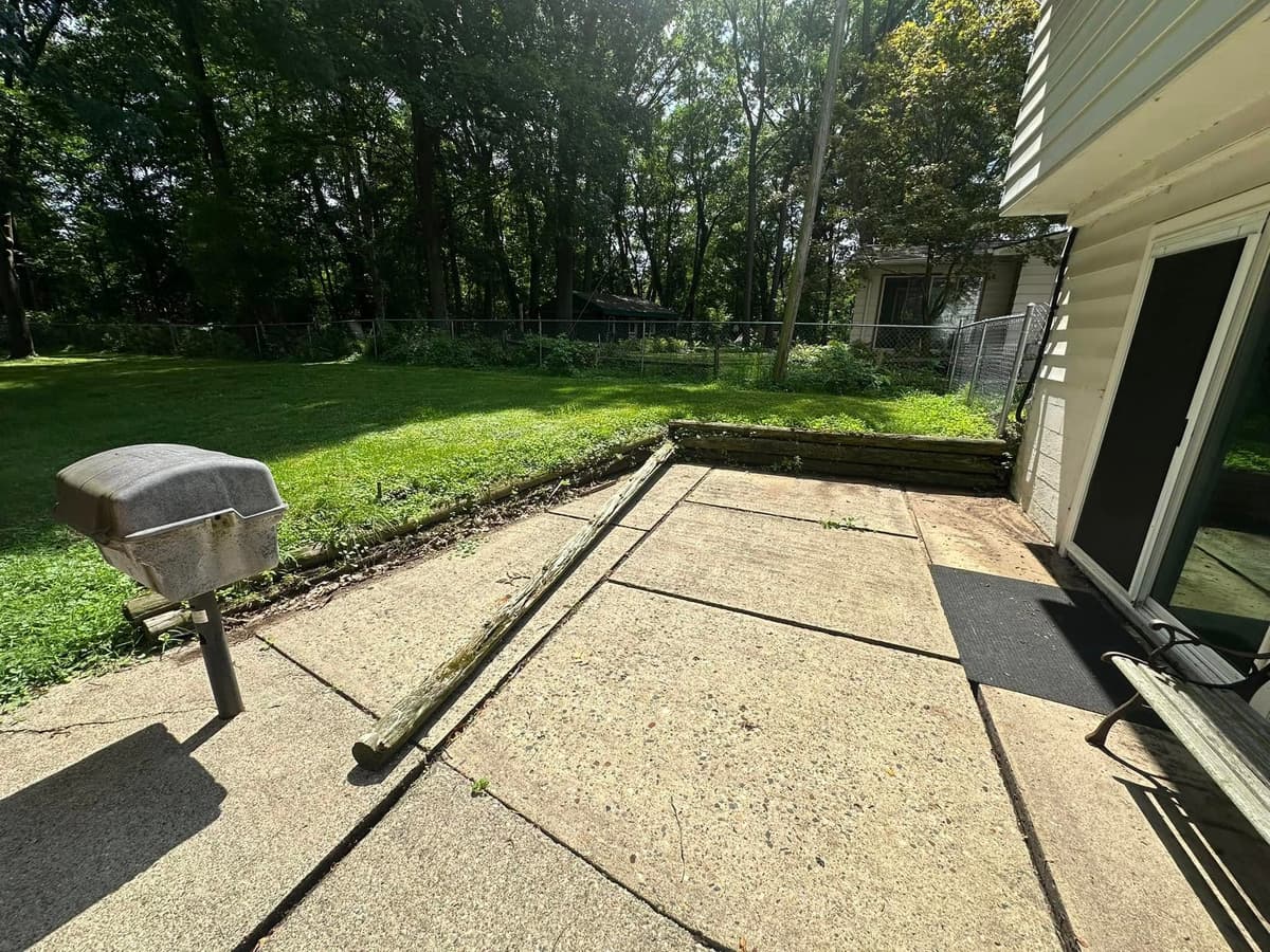 Sloped yard with erosion problems before retaining wall installation